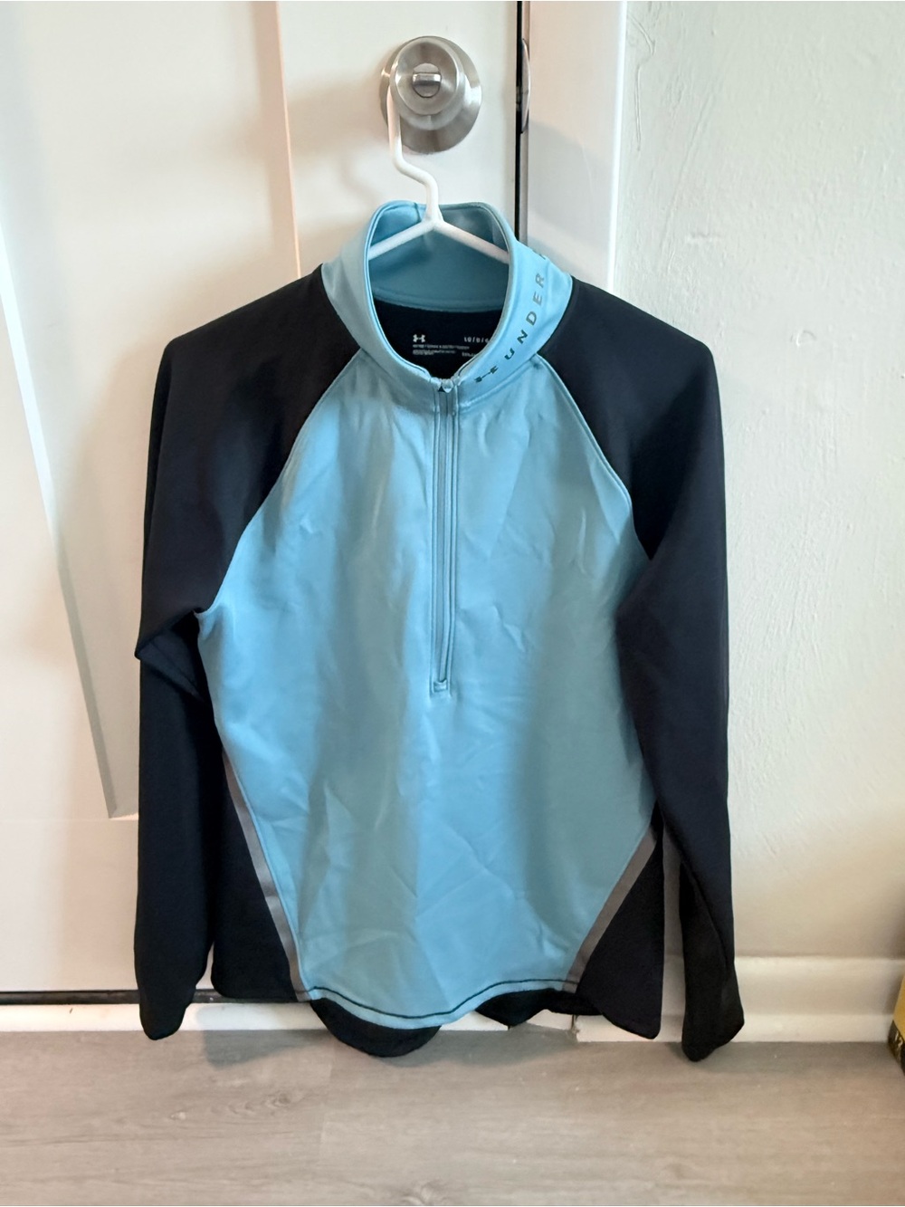 Under Armour women’s Light Blue & Black Long Sleeve 1/4 zip up.